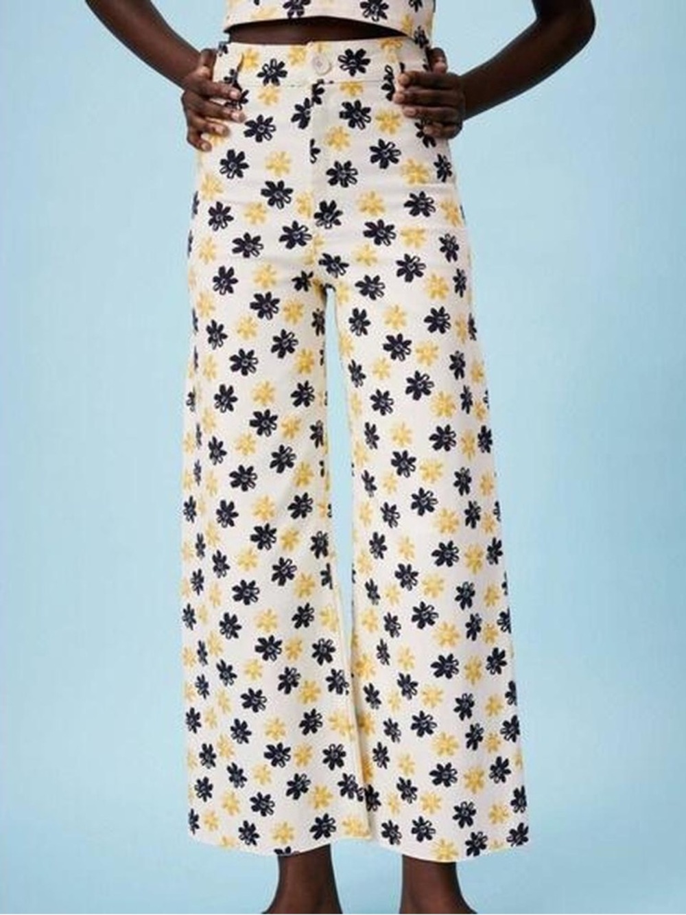 beige zara pants with black and yellow flower patterns. wide, high-waisted pants